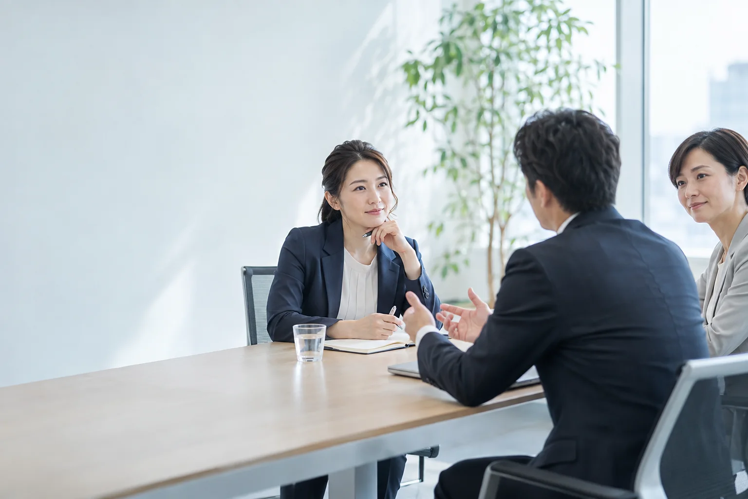 会議室で依頼主の話を聞くコンサルタント
